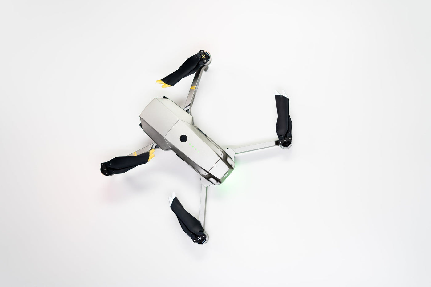 White and Black DJI Mavic Drone on White Surface